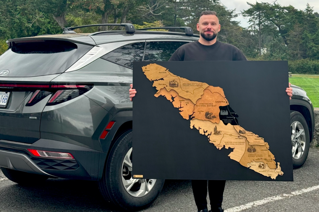 4 × 3 ft wooden Vancouver Island map on a matte black wooden backing board, delivered and hung in the office of a local business in Victoria, BC.