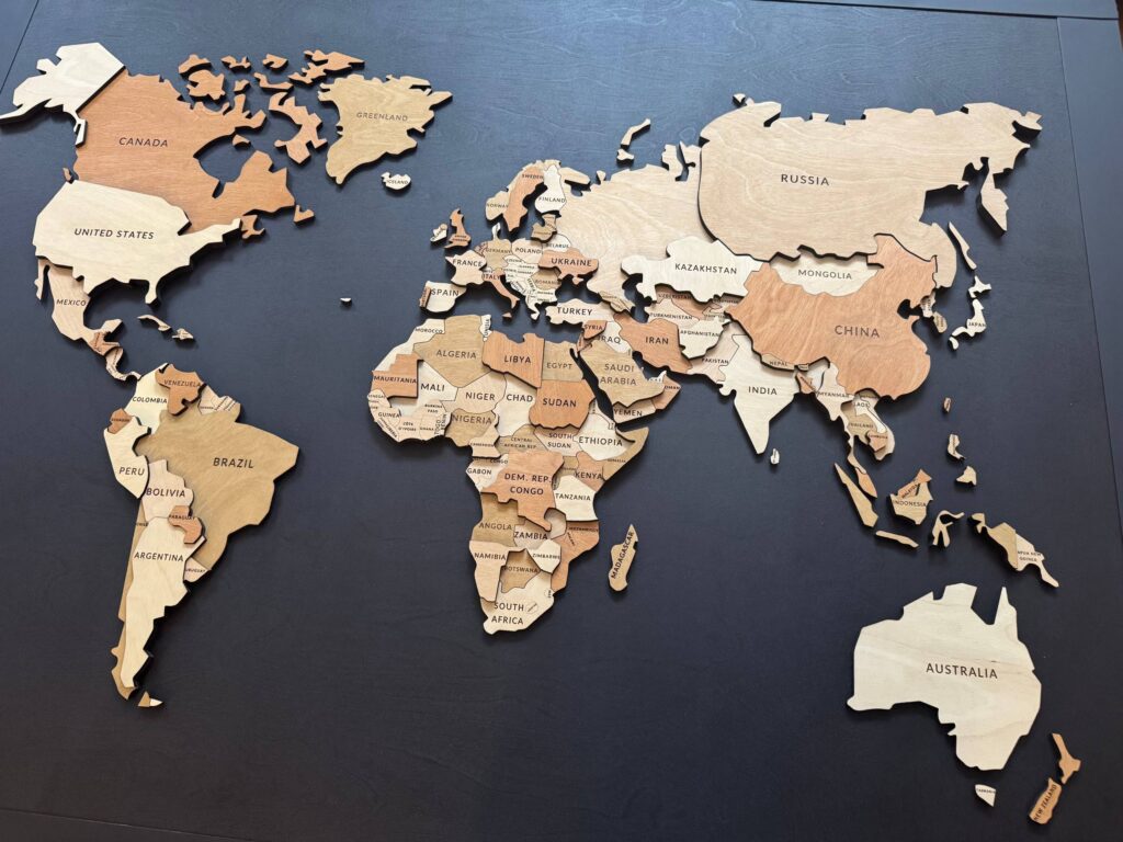 4 × 5 ft wooden world map with a metal frame for travel magnets, created for a home near Shawnigan Lake on Vancouver Island.